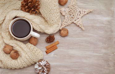 Fototapeta na wymiar Cup of coffee and warm knitted sweaters.