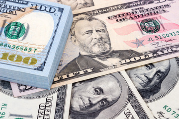 Heap of one hundred banknotes of american dollars close up