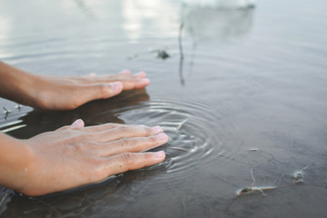 Close up hand of girl and nature water