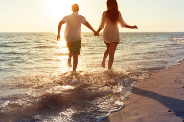 Happy young couple enjoying the sea