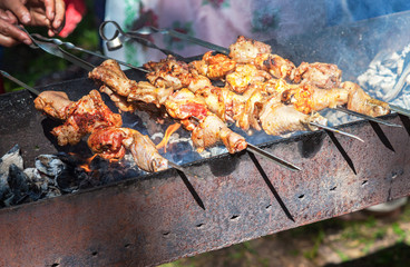 Appetizing hot shish kebab on metal skewers