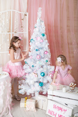 Fototapeta na wymiar Two sisters in a Christmas decorations