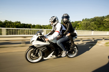 Young man and a woman on a motorcycle