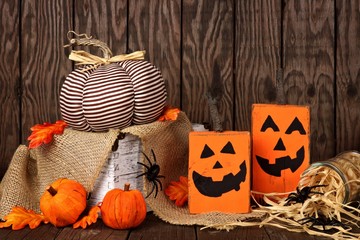 Rustic shabby chic Halloween decor against an old wood background