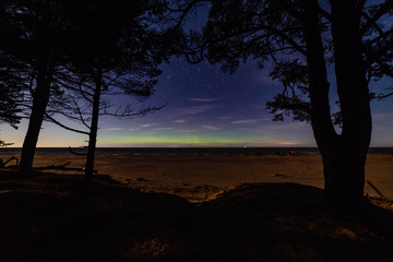 intense northern lights aurora borealis over beach