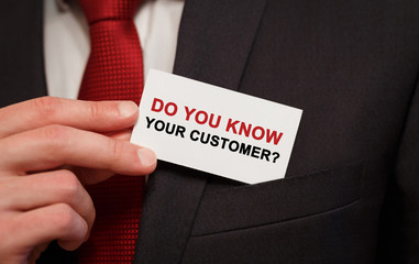 Businessman putting a card with text Do you know your customer in the pocket