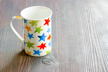 White mug with multicolored stars