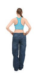 Young woman in oversized jeans on white background. Diet concept