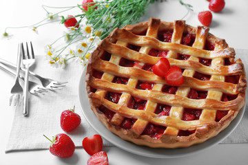 Delicious strawberry pie on table