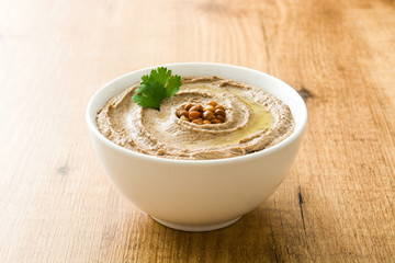 Lentil hummus in bowl on wood