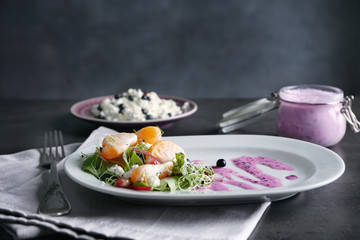 Delicious superfood salad served with pink sauce on white ceramic plate in kitchen