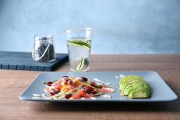 Superfood salad with beans and zucchini on plate in kitchen