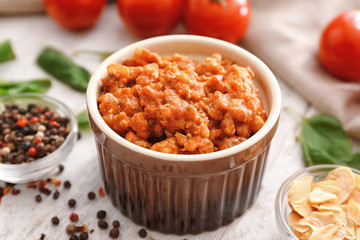 Meat sauce in ceramic bowl on kitchen table