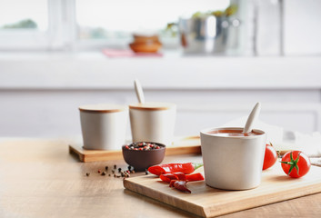 Composition with chili sauce in cup on table