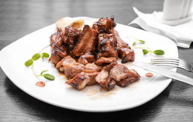 Delicious juicy ribs on dinner table