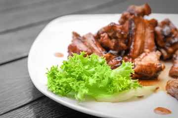 Delicious ribs served with salad on dinner table