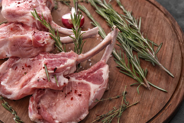 Raw ribs and seasoning on kitchen table