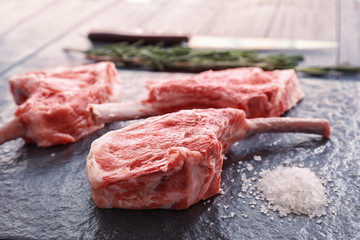 Raw ribs and salt on kitchen table