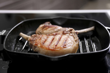 Two juicy ribs on grill pan