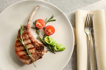 Delicious rib served with rosemary and vegetables on dinner table