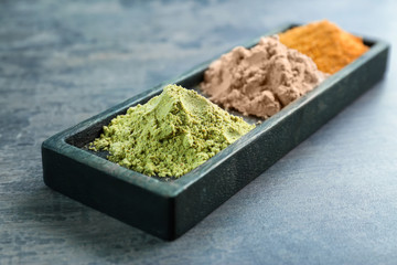 Various colorful superfood powders on color background