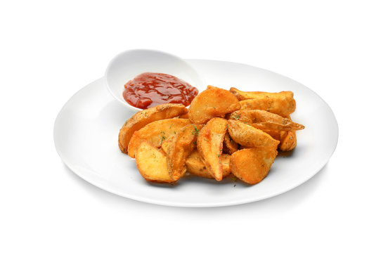 Plate with delicious baked potato wedges and sauce on white background