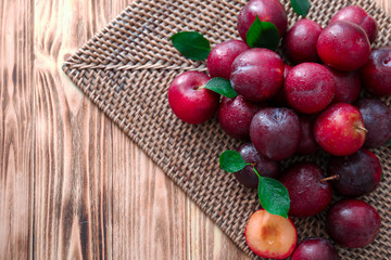 Fresh ripe plums on wooden table