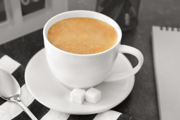 Cup of aromatic morning coffee on table
