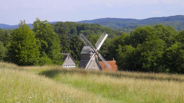 landschafts panorama mit wald, wiese und windm&uuml;hle im teutoburger wald