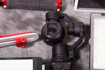 Fototapeta premium Close up of an Osmo Mobile gimbal, new generation of electronic stabilizer over a gray background
