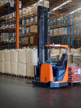 Reach trucks for perfect load control, material handling happens smooth and precisely in large warehouse.