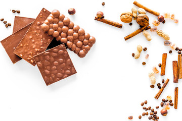 Chocolate bars on white background top view copyspace