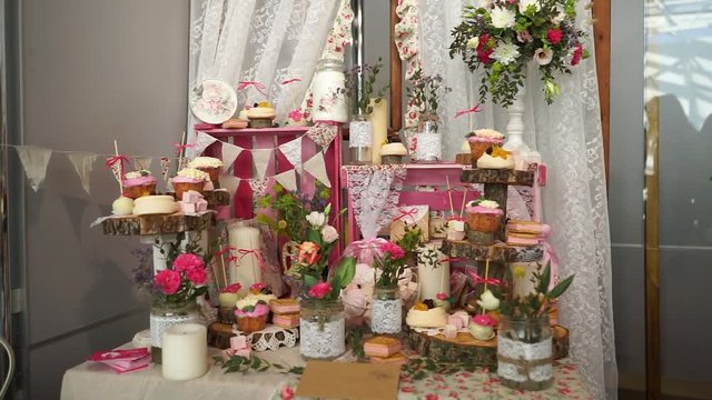 White sweets on gilded paper on the wedding candybar.