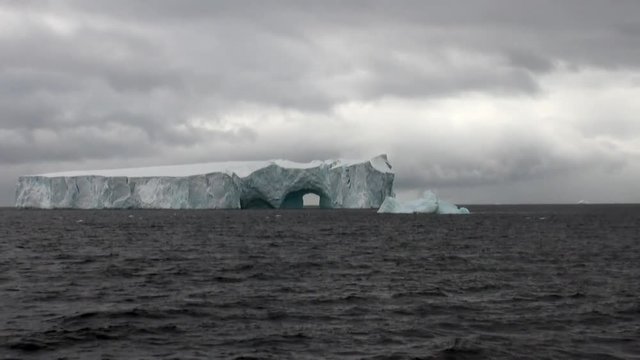Arch of Darwin unique glacier iceberg in ocean of Antarctica. Amazing beautiful wilderness nature and landscape of white mountains. Extreme tourism cold desert north pole.