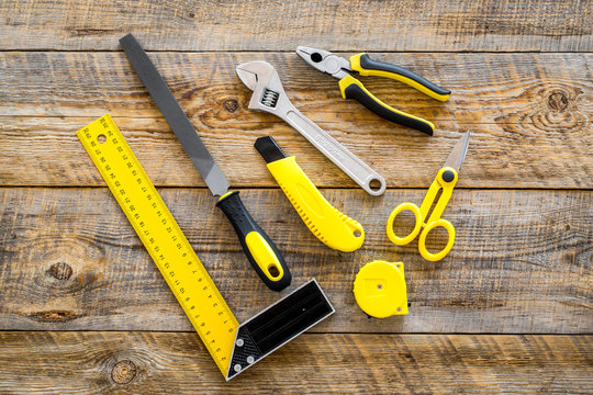 constructor desk with set of building implements wooden desk background top view