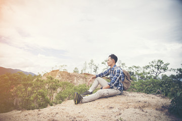 young male backpacker enjoy the view at mountain peak