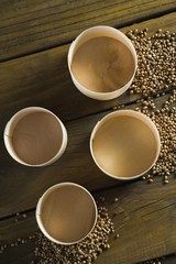Plastic bowls and coriander seeds scattered 