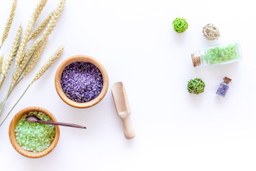 home spa with wheat herbs cosmetic salt for bath on white desk background top view