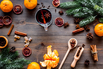 Ingredients mulled wine or grog with spices and citrus for winter evening. Christmas new year eve. Wooden background top view.