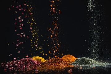 Powdered spices against black background - Powered by Adobe