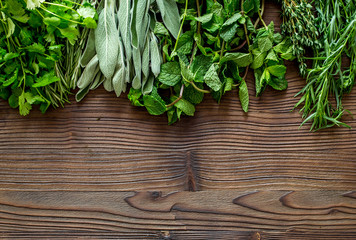 making spices with fresh herbs and greenery for cooking wooden kitchen table background top view mockup