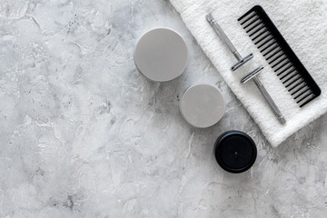 Men's shaving. Tools and cosmetics on grey stone background top view copyspace