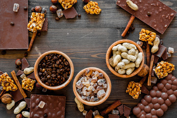Mockup with chocolate on dark wooden background top view