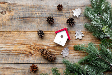 new year 2018 greeting pine cones and house decorations on wooden background top veiw space for text