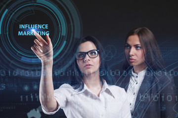 The concept of business, technology, the Internet and the network. A young entrepreneur working on a virtual screen of the future and sees the inscription: Influence marketing