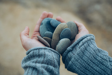 Hands and stones in blue