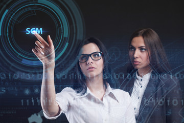 The concept of business, technology, the Internet and the network. A young entrepreneur working on a virtual screen of the future and sees the inscription: SCM
