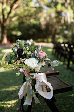 Wedding flowers in ceremony aisle