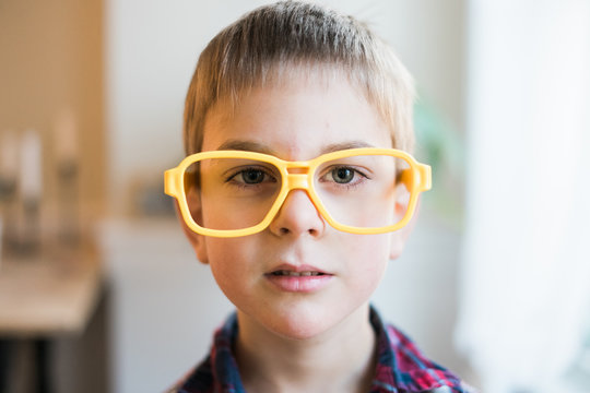 little boy with yellow plastic glasses