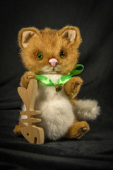 Doll sitting fluffy red cat with fish